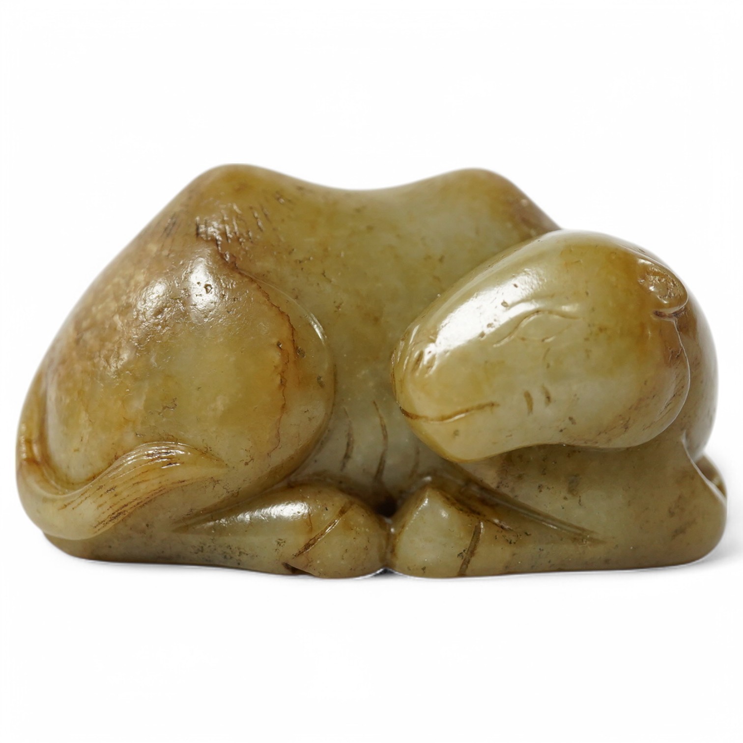 A Chinese carved jade figure of a recumbent Bactrian camel, 7.5cm long. Condition - good